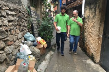 Jorge stands next to Gabriel in an alley.